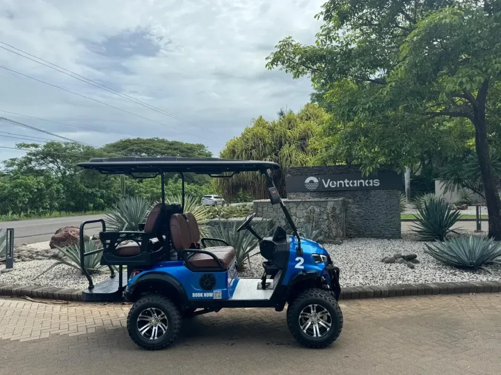 Four seater golf cart with two forward seats and two rear facing seats, Playa Grande