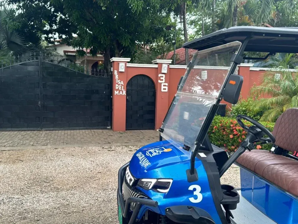 Go Grande golf cart waiting outside a home in the Playa Grande area