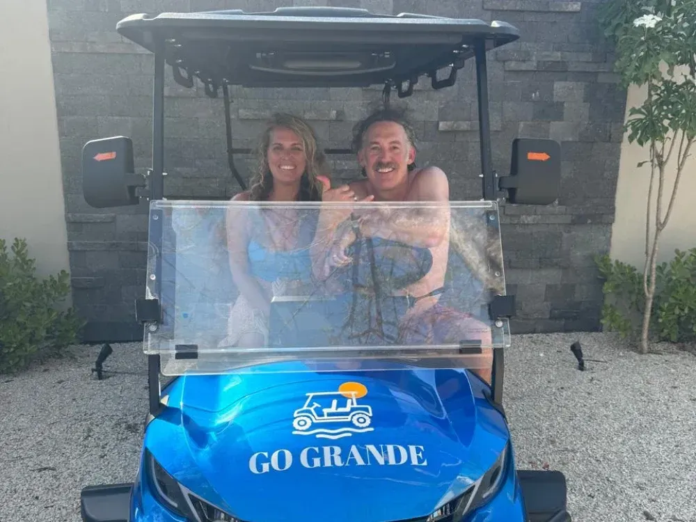 Guests sitting in a Go Grande golf cart in Playa Grande, Costa Rica